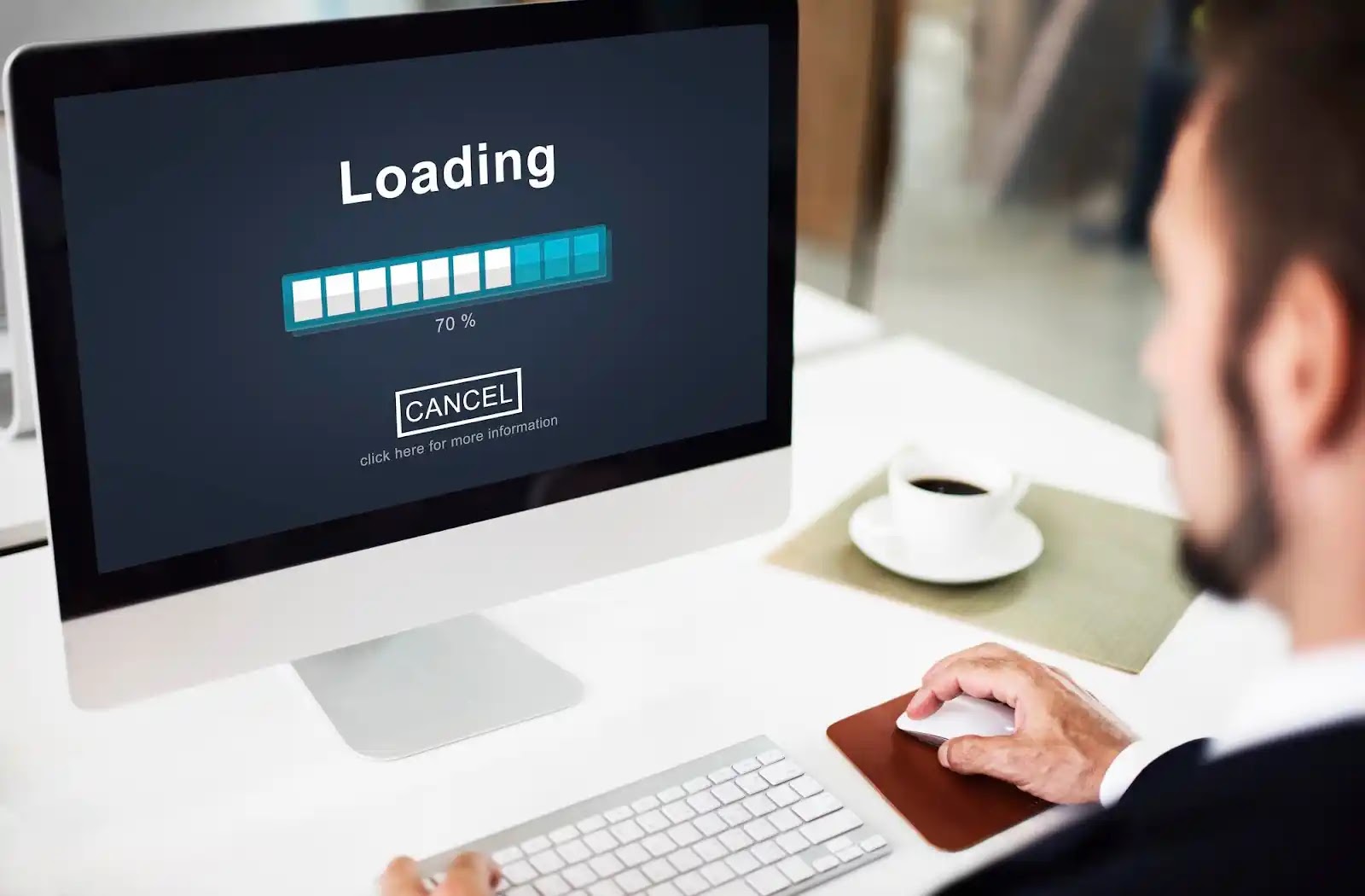 A person waiting in front of a computer for a page to load