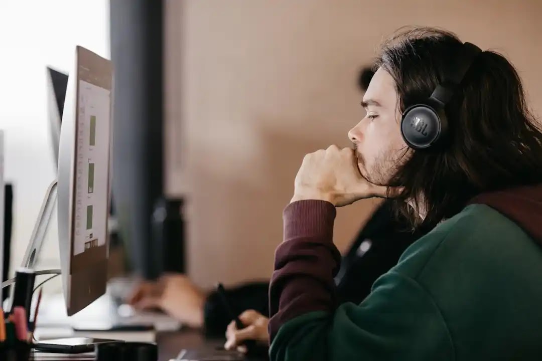 A man reviewing telecom expense management services to monitor and manage telecommunications costs and infrastructure. A man reviewing telecom expense management services to monitor and manage telecommunications costs and infrastructure.